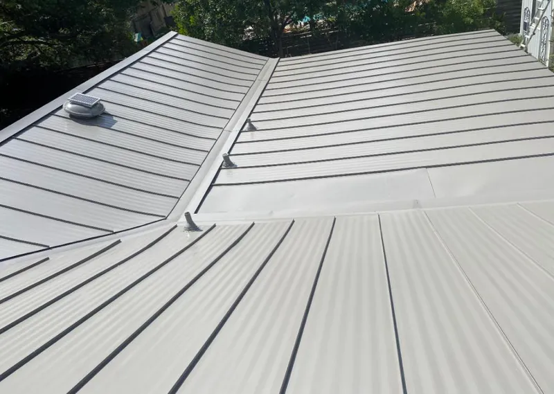 Solar attic fan installed on a metal roof for Roof Ventilation in Panama City