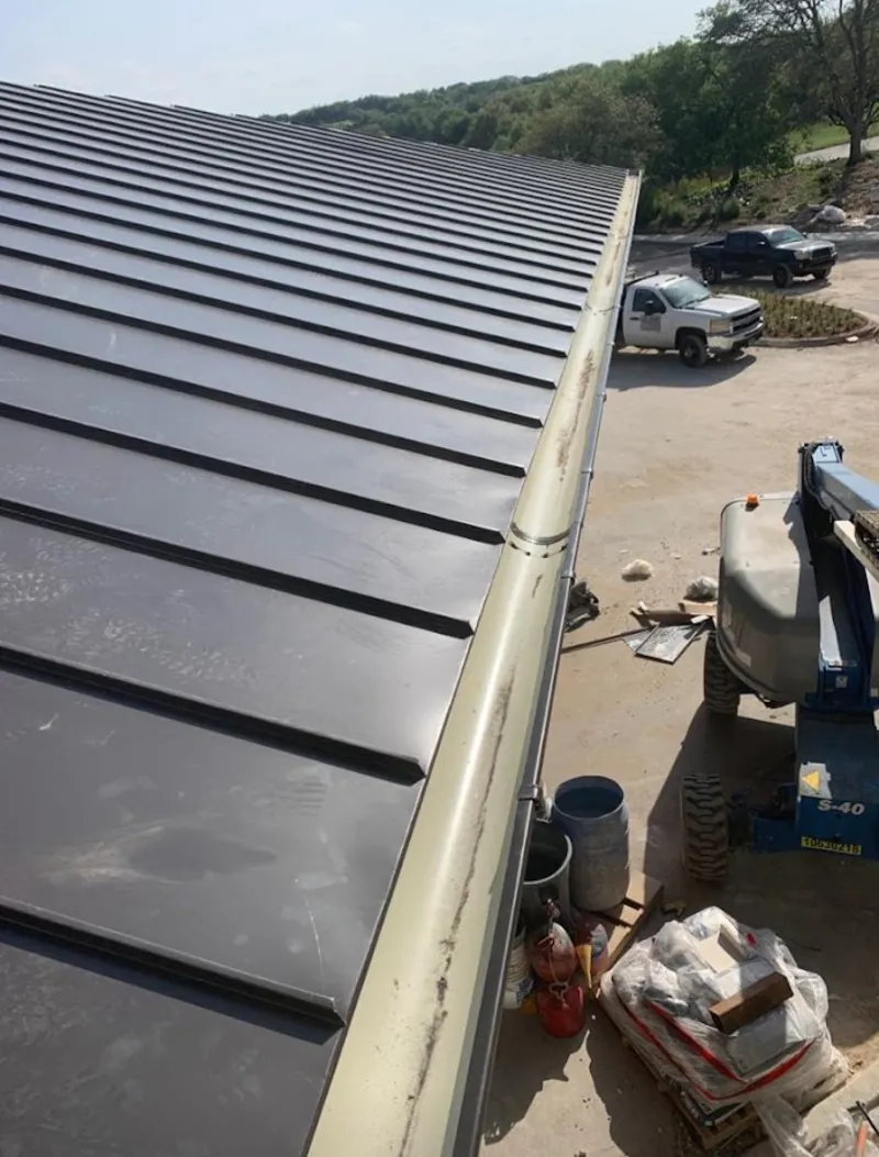 Standing seam panel and gutter detail on a metal roofing jobsite in Panama City